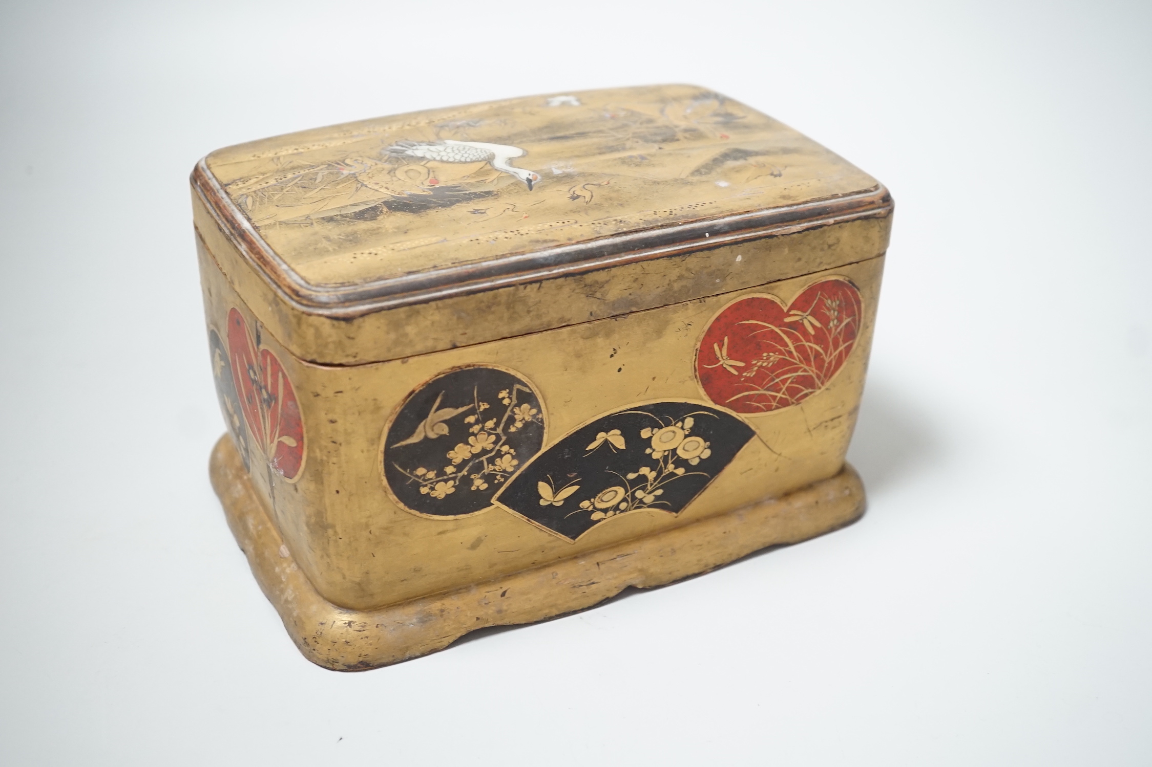 A Japanese lacquered box and cover accommodating a small collection of seashells